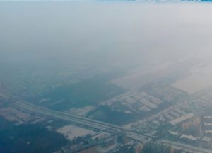 A cloud of carbon emissions over a town.