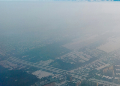 A cloud of carbon emissions over a town.